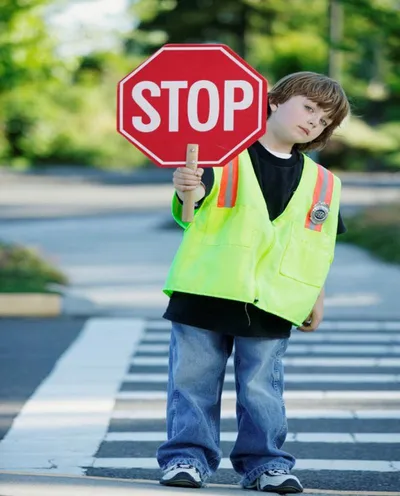 Child holding construction safety awareness sign promoting workplace safety education